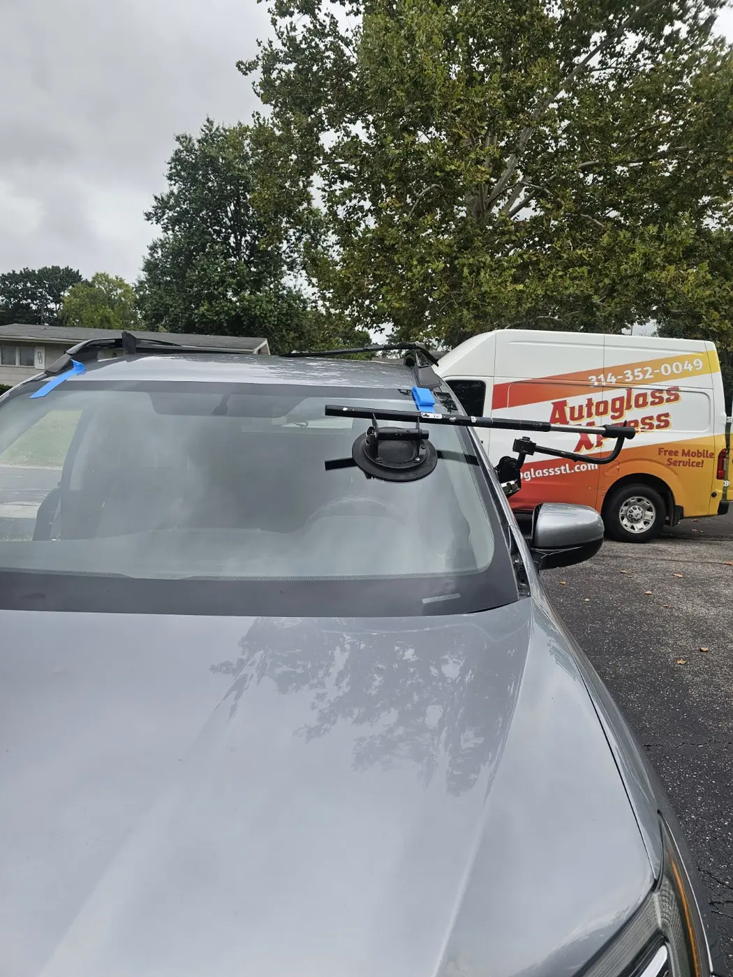 Auto Glass Xpress mobile windshield installation with professional glass-setting equipment and service van